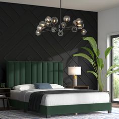 a bedroom with black walls and green headboard