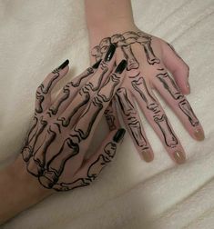 two hands with black and white designs on them