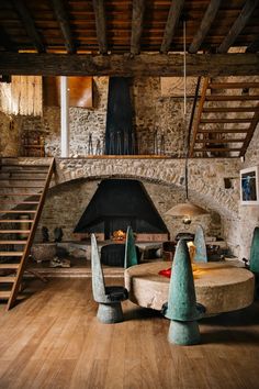 a living room filled with furniture and a fire place in the middle of it's walls