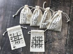 four drawstring bags with the words tic - tac toe tot on them