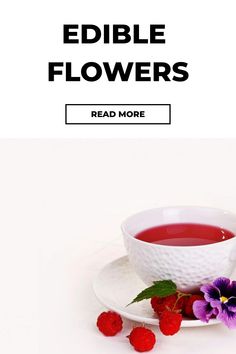 a white plate topped with raspberries next to a cup of tea and flowers