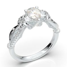 a white gold engagement ring with an oval cut diamond center and vine design on the band