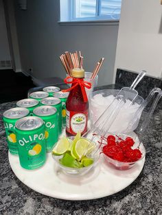 the drinks are ready to be served on the trays with strawberries and limes