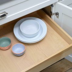 the dishes are sitting on the drawer in the kitchen