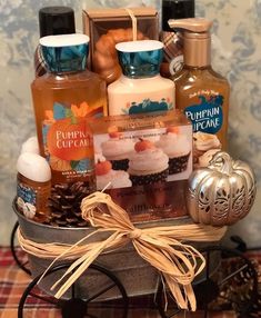 a gift basket with candles, soaps and other items in it on a table