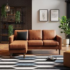 a brown leather couch sitting on top of a black and white checkered rug in a living room