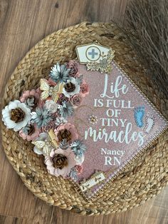 a hat with flowers on it sitting on top of a wooden floor next to a basket