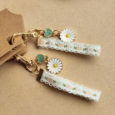 Gold Toned Chain & Spring Ribbon With White Enamel Daisy And Sage Green Heart Adornments. Approximately 5" Long And 2 Oz. Made In Usa. Sage Green Heart, Ribbon Keychain, Green Heart, Key Card Holder, White Enamel, Card Holders, Sage Green, Made In Usa, Gold Tones