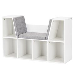 a white book shelf with a grey cushion on top and two shelves below the seat