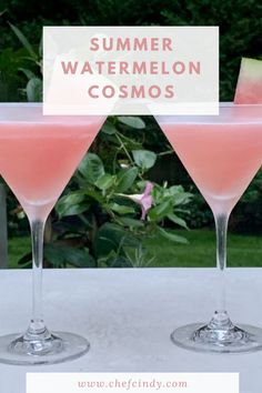 two glasses filled with watermelon cocktails sitting on top of a table