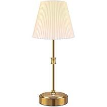 a lamp with a white shade on top of it and a gold base, in front of a white background