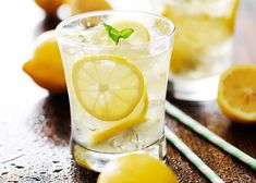 a glass filled with ice and lemon slices