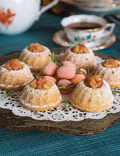 small pastries on a plate with tea in the background