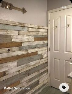 a bathroom with wood planks on the wall