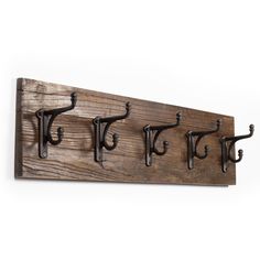 a wooden coat rack with four hooks on it