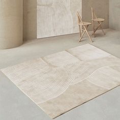 a chair and rug in an empty room