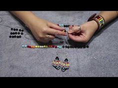 a woman is making beaded bracelets with beads