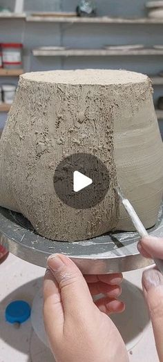 someone is making a clay sculpture on a plate