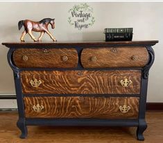 a toy horse is standing on top of a dresser