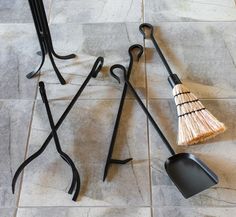 three different types of brooms laying on the floor