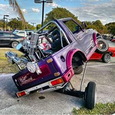 an odd looking car is parked in a parking lot