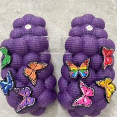 two purple balls with colorful butterflies on them