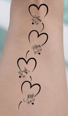 the back of a woman's leg with three hearts on it and two names written in