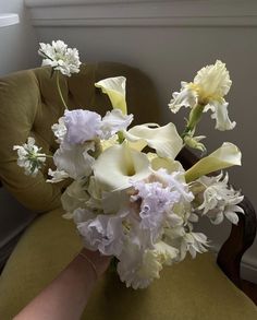 a bouquet of flowers sitting on top of a chair