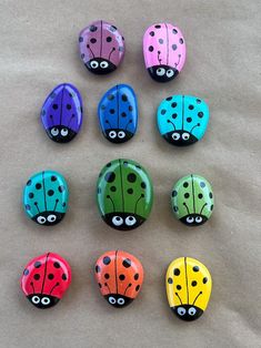 six ladybug magnets with eyes painted on them