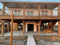 a large house with two balconies on the second floor and an attached deck