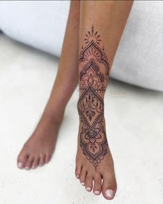 a woman's foot with a tattoo on it