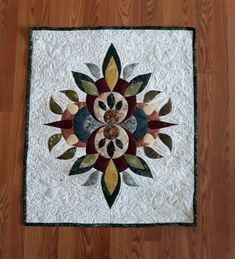 a close up of a quilt on a wooden floor