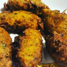 some fried food on a white plate with a yellow and black sticker next to it