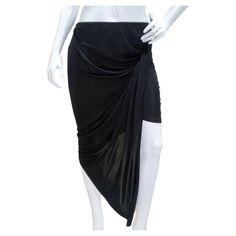 Step into the epitome of contemporary elegance with the Mugler Black Draped Skirt, a mesmerizing piece that effortlessly combines modernity and versatility. Crafted from stretch-jersey, this midi skirt is a masterclass in design, featuring meticulous gathering and draping to create a stunning asymmetric silhouette. The dynamic design not only showcases the craftsmanship but also accentuates your curves in a tasteful and flattering manner. The stretch-jersey fabric ensures comfort without comprom Ethereal Dramatic, Mugler Black, Gonna Midi, Gucci Boots, Black Drapes, Draped Skirt, Dynamic Design, Asymmetrical Skirt, Sleek Look