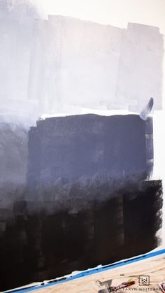 an abstract painting with black and white colors on the wall, including paint rollers