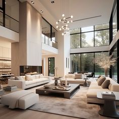 a large living room with high ceilings and floor to ceiling windows, white couches and chairs