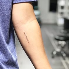 a person with a small tattoo on their arm