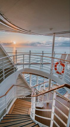 the sun is setting over the ocean as seen from the upper deck of a cruise ship