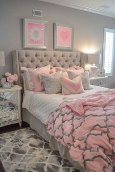 a bedroom with pink and gray decor on the walls