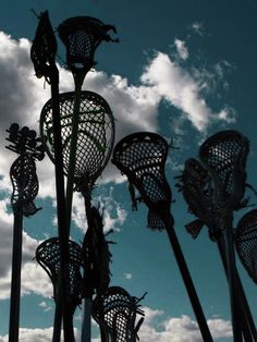 several metal sculptures are shown against the blue sky