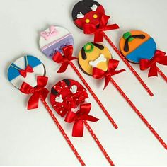 several lollipops with bows and designs on them sitting next to each other