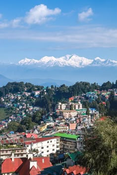 a city with snow capped mountains in the background