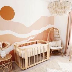 a baby's room with a crib, rocking chair and wall mural in the background