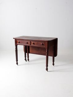 a small wooden table with two drawers