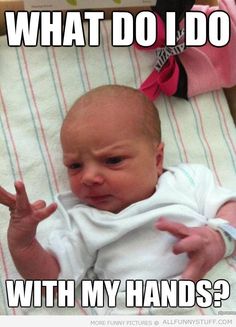 a baby sitting on top of a bed with the caption what do i do with my hands?