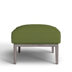 a green ottoman sitting on top of a white floor