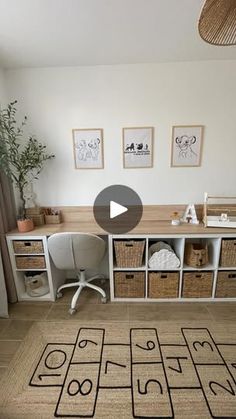 a living room with an area rug and some pictures on the wall, including a chair