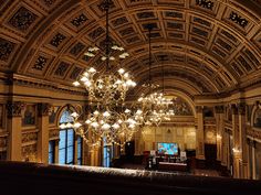 chandelier hanging from ceiling in ornately decorated building