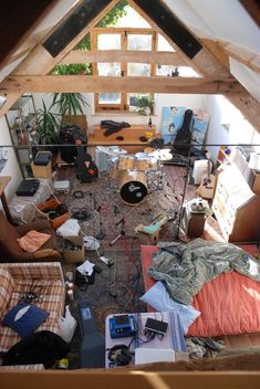 an overhead view of a messy living room with furniture and clutter on the floor