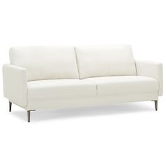 a white couch sitting on top of a wooden floor